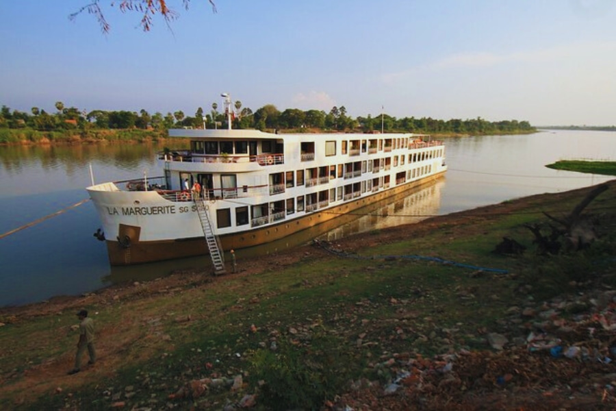 La Marguerite Mekong River Cruise docked beside peaceful riverside scenery Vietnam